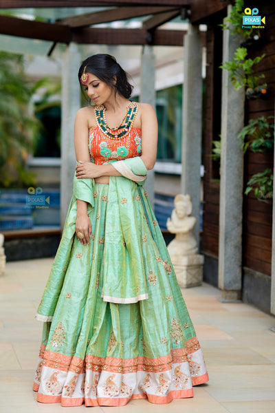 Bright orange floral embroidered corset blouse  with green tissue lehenga and dupatta