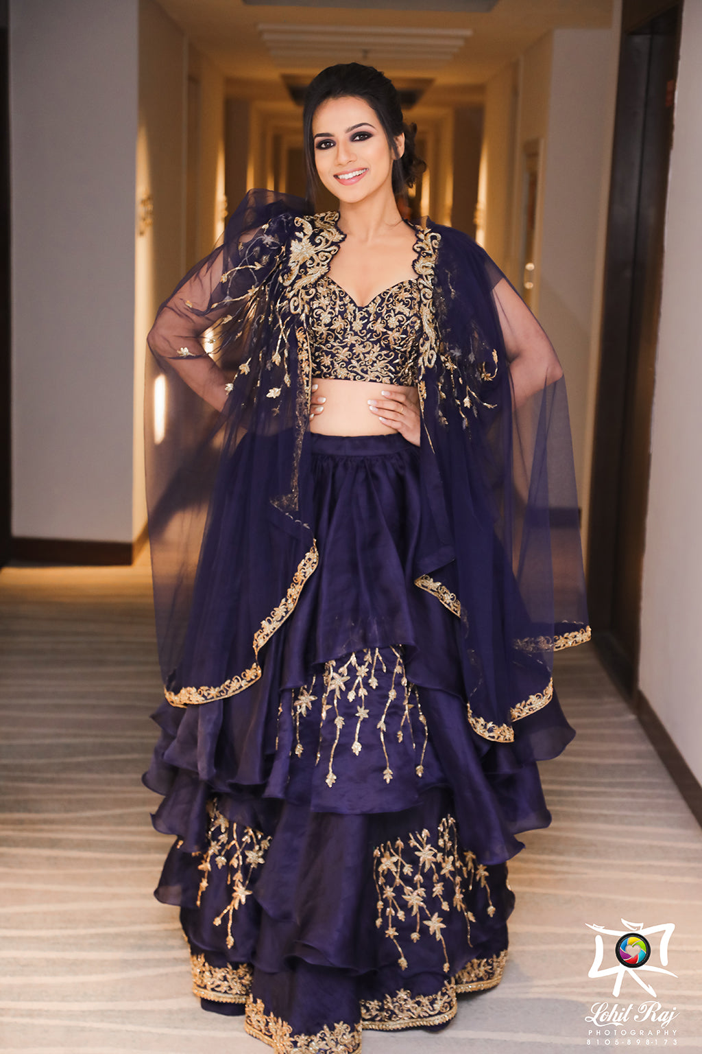 Layered organza embroideredlehenga with bustier blouse and tulle cape