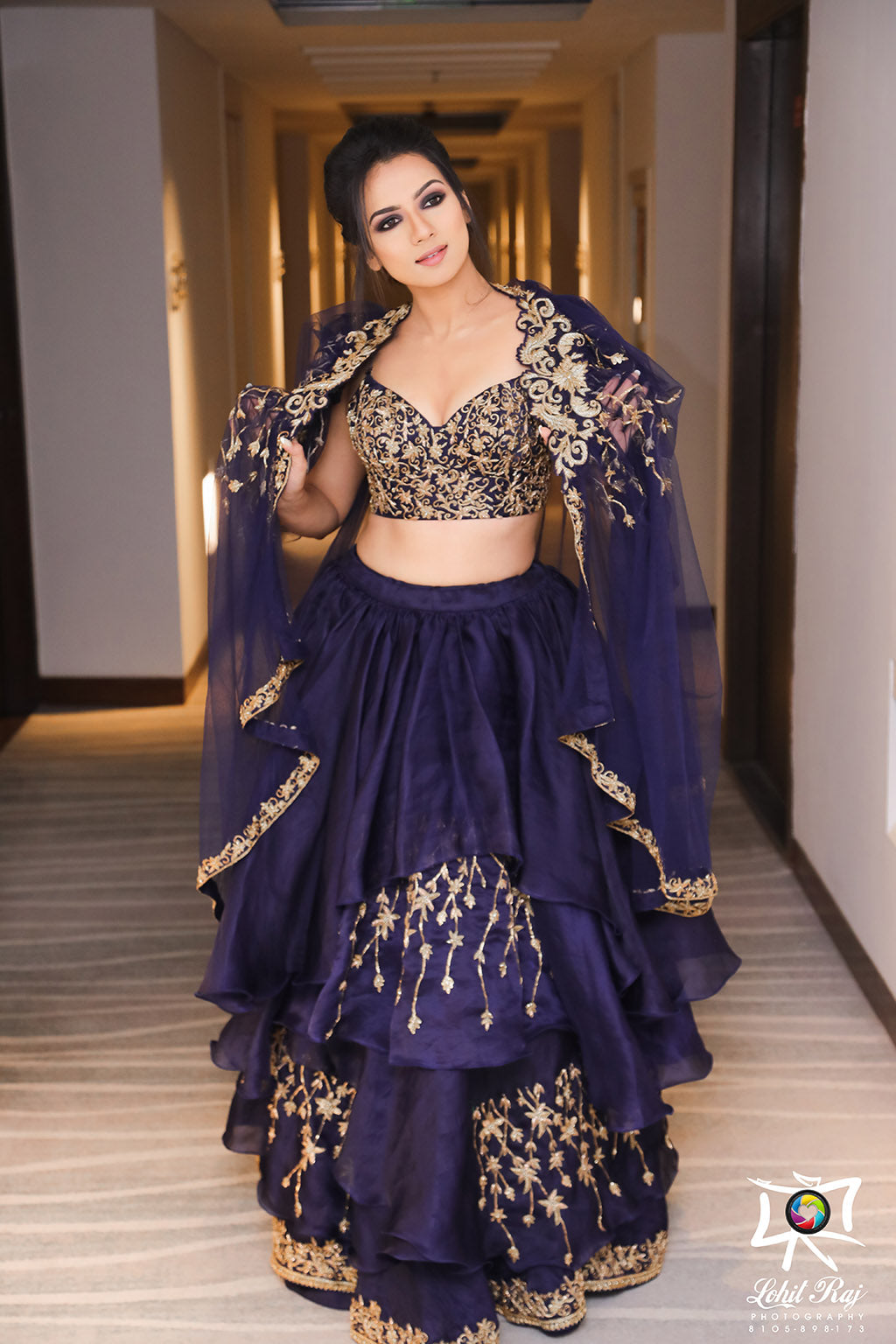 Layered organza embroideredlehenga with bustier blouse and tulle cape