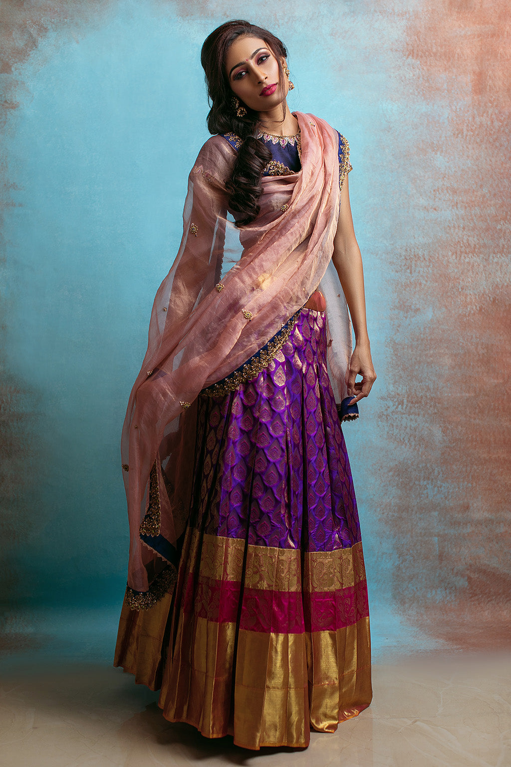 High neck blouse with purple kanchi skirt and tissue blush dupatta