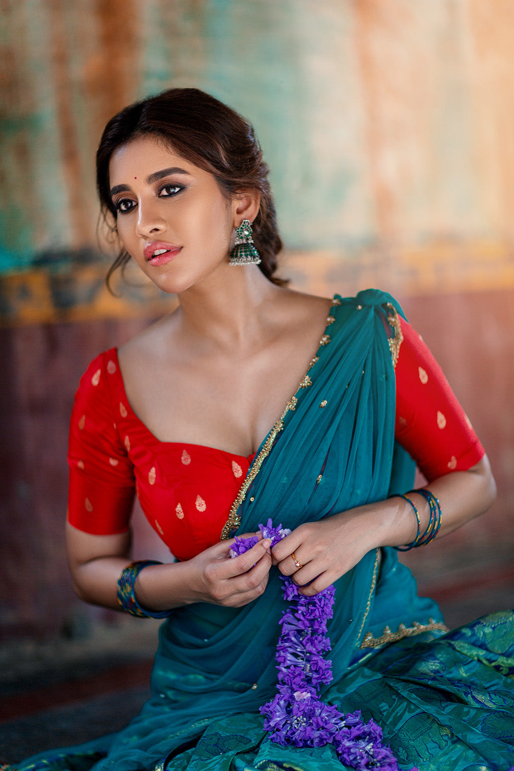 Sweetheart neck red brocade silk blouse with blue knife pleat kanchi silk skirt and blue tulle dupatta