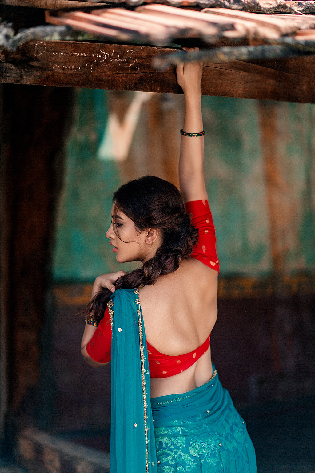 Sweetheart neck red brocade silk blouse with blue knife pleat kanchi silk skirt and blue tulle dupatta