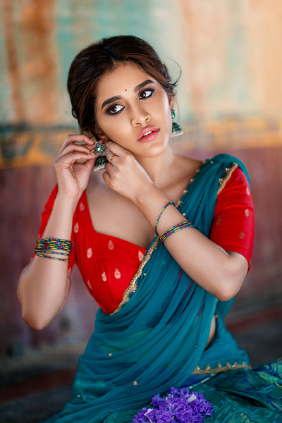 Sweetheart neck red brocade silk blouse with blue knife pleat kanchi silk skirt and blue tulle dupatta