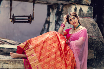 Pink blouse with zari border sleeve, orange pleated kanchi skirt and pink tulle embroidered dupatta