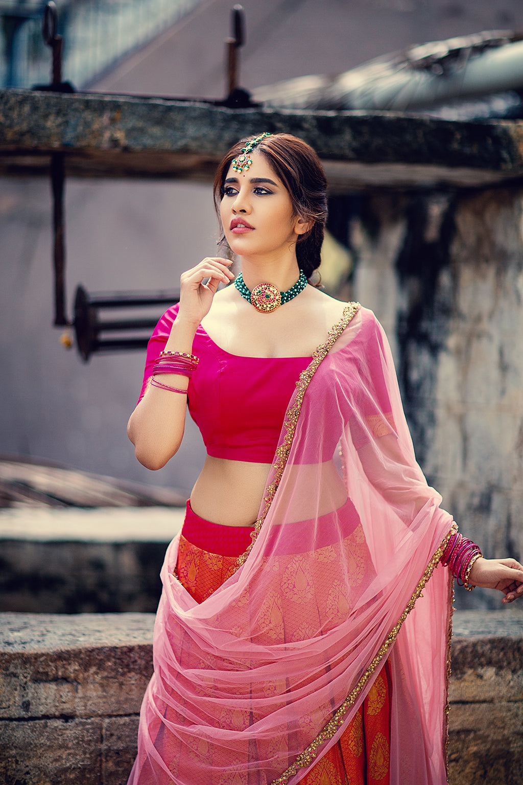 Pink blouse with zari border sleeve, orange pleated kanchi skirt and pink tulle embroidered dupatta