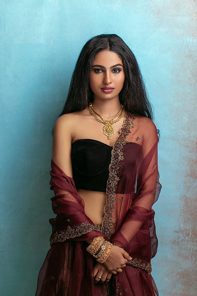 black velvet bustier blouse,black gold mix tissue gathered lehenga,with organza dupatta