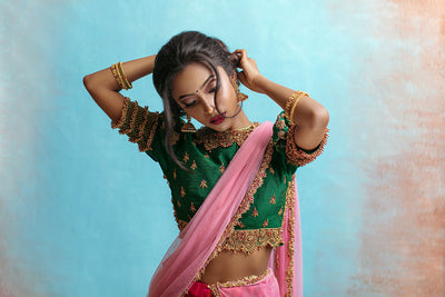 Puff sleeve high neck jewel blouse with red and green draped silk skirt and tulle dupatta