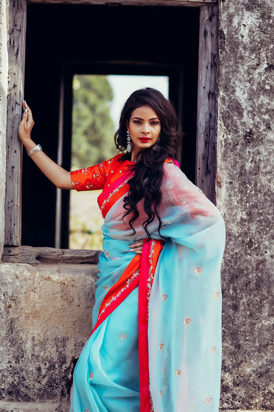 Boat neck raw silk orange blouse with blue organza saree